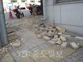 ▲ 공주시가 추진하는 하수관거사업 공사장에 안전장치가 미흡해 시민들이 불편을 겨고 있다. 사진은 뜯어 쌓놓은 블록들이 관리가 안돼 여기저기 흩어진 채 방치된 모습.