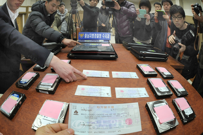 ▲ 충남교육청 교육전문직(장학사ㆍ교육연구사) 선발시험 문제 유출사건 수사 브리핑이 열린 14일 충남지방경찰청 대회의실에 경찰이 압수한 수표 2억3000여만원과 컴퓨터 등 증거물들이 놓여 있다. 김상구 기자