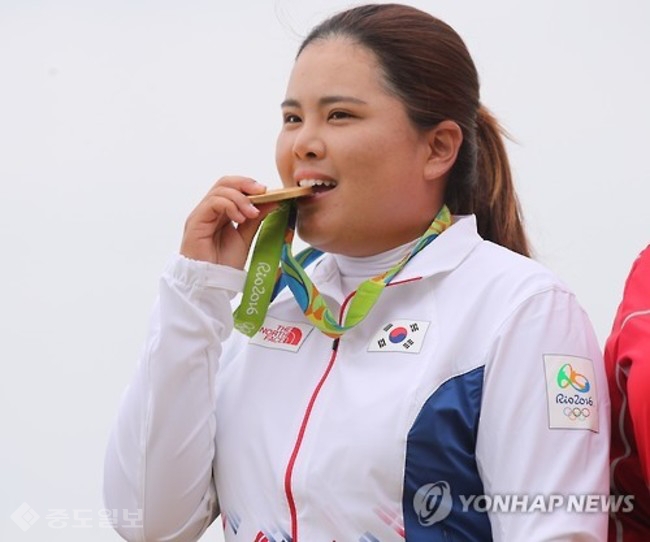 ▲ 여자 골프에서 금메달을 획득한 박인비가 시상식에서 메달을 깨무는 포즈를 취하고 있다. 사진제공=연합뉴스