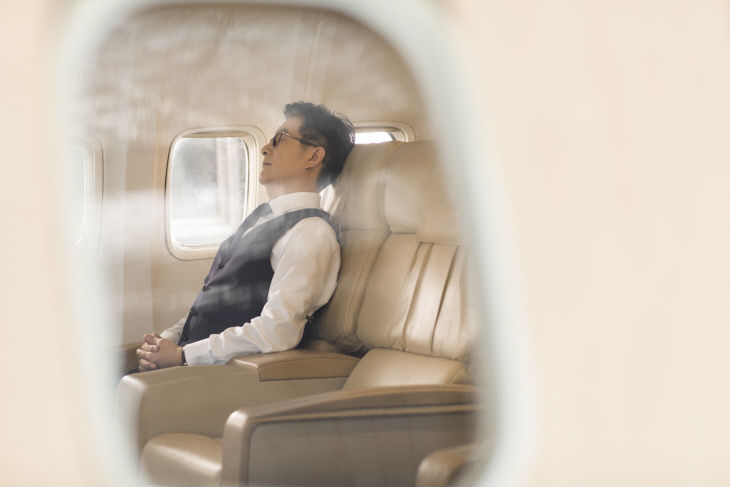 Senior businessman sleeping on airplane